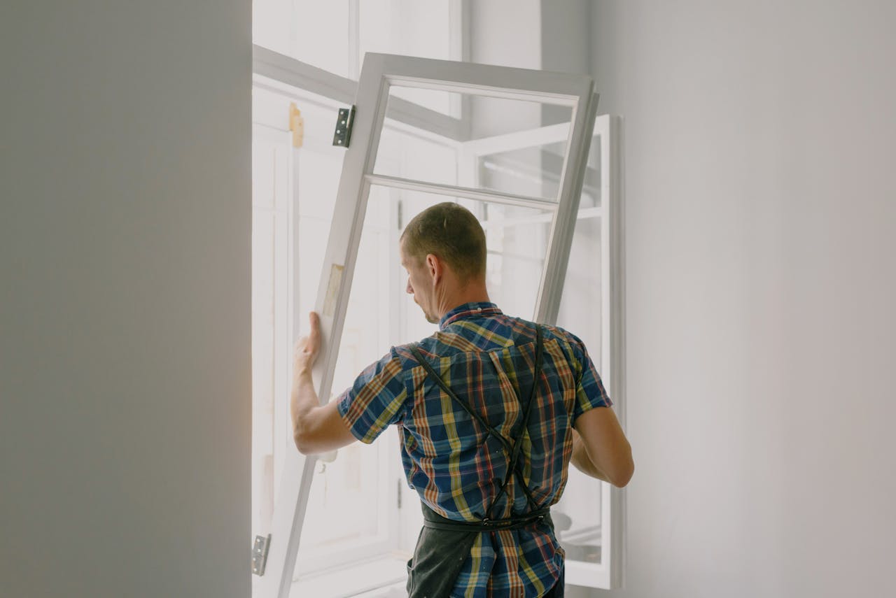home-hero A professional installer fitting a modern window in a well-lit home interior.